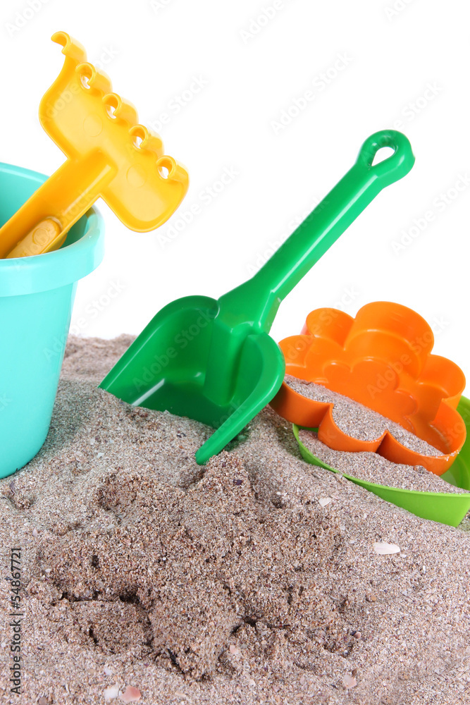 Children's toys on sand isolated on white Children's toys on sand isolated on white