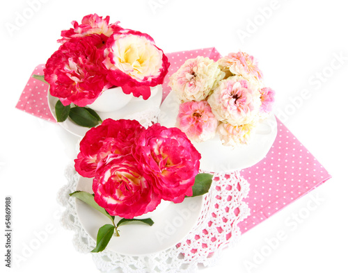 Roses in cups on napkins isolated on white