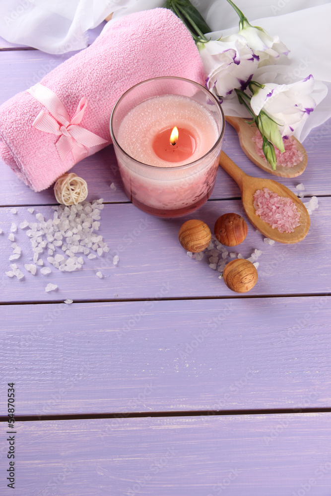 Beautiful spa setting with pink candle and flowers Beautiful spa setting with pink candle and flowers