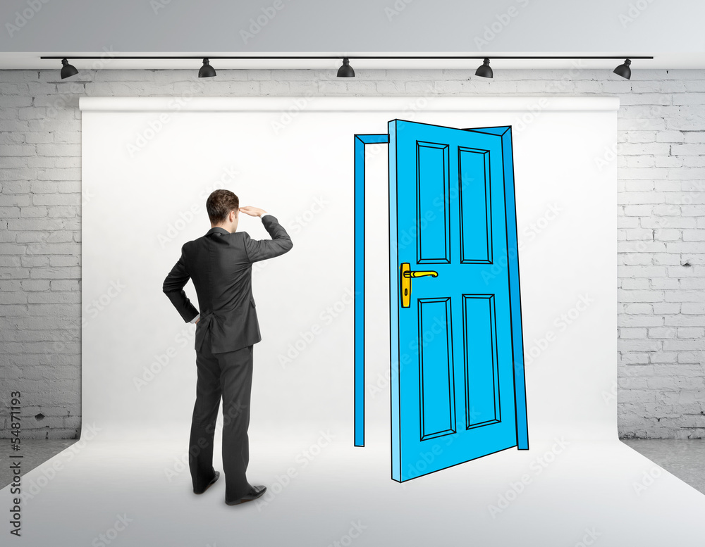 Fototapeta premium businessman looking at drawing door