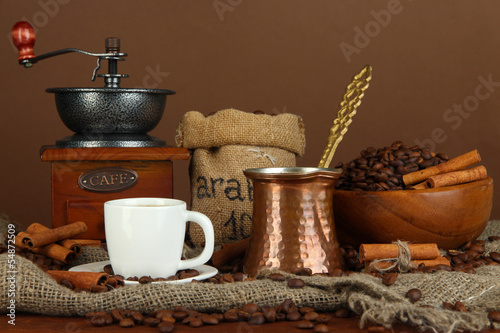 Metal turk and coffee cup on dark background