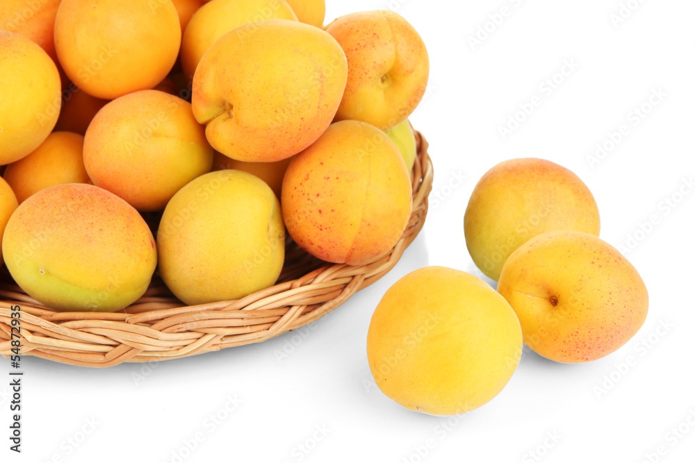 Fresh natural apricot in wicker basket isolated on white Fresh natural apricot in wicker basket isolated on white
