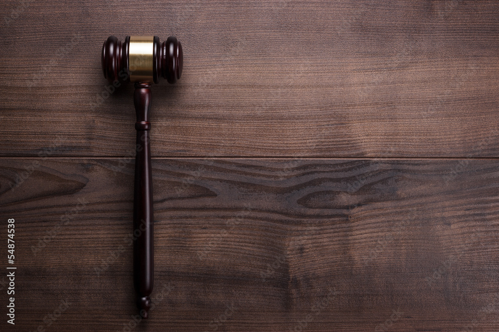 judge gavel on the brown wooden background judge gavel on the brown wooden background