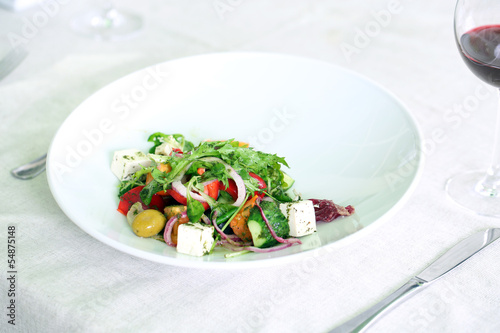 Greek salad on white plate, close up