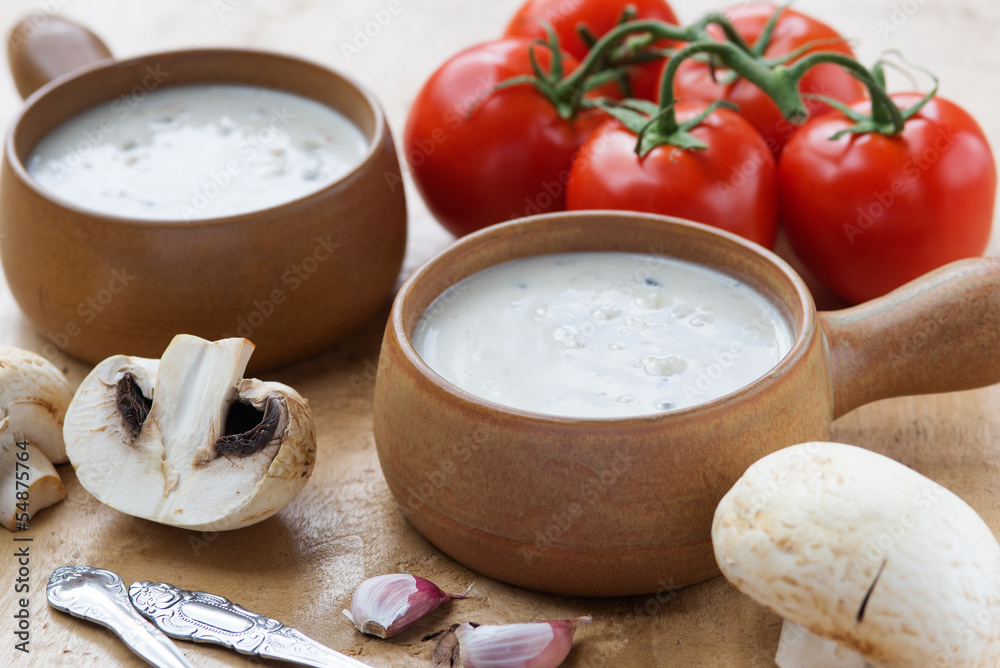 Creamy mushroom soup in two clay pots Creamy mushroom soup in two clay pots