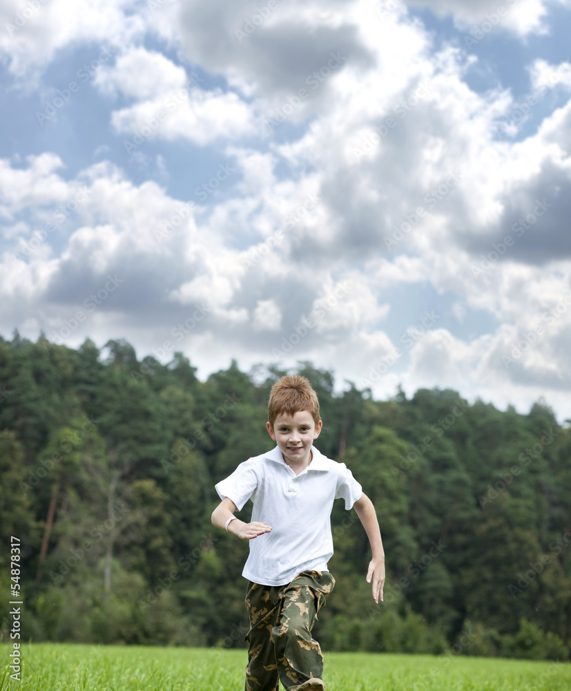 Little boy running on the meadow in summer day Little boy running on the meadow in summer day
