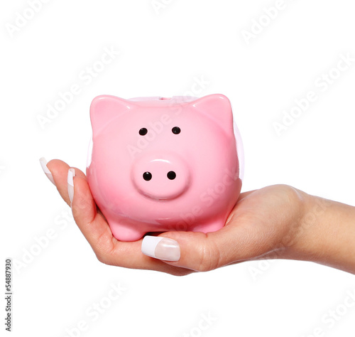 Piggy bank in female hand isolated on white background. Savings