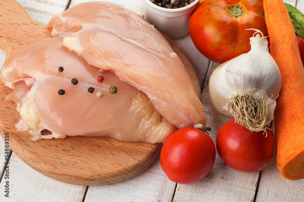 Fresh chicken on wooden table
