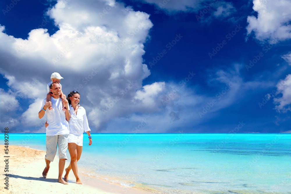 View of happy young family having fun on the beach View of happy young family having fun on the beach