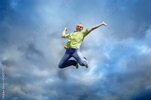 Jump of man under sky with clouds