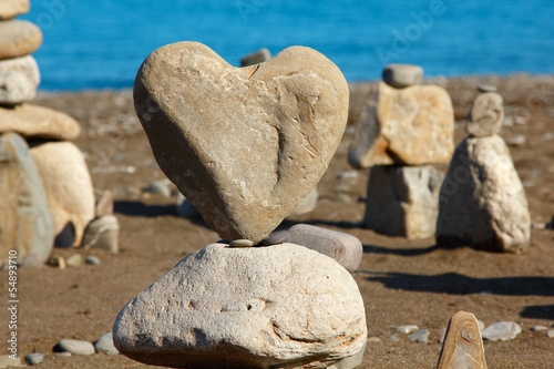 Photography group of balanced stones with rock's heart at front view, pebble