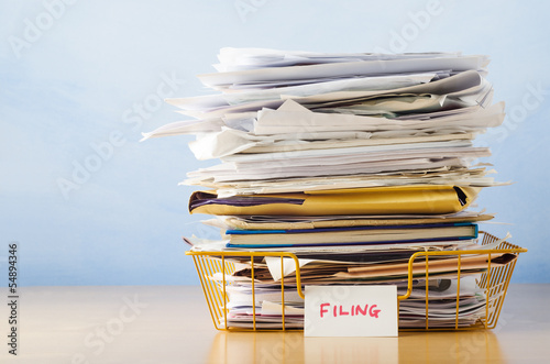 Filing Tray Piled High with Documents photo