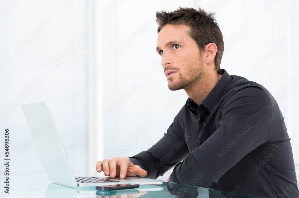 Pensive Businessman Working On Laptop Pensive Businessman Working On Laptop