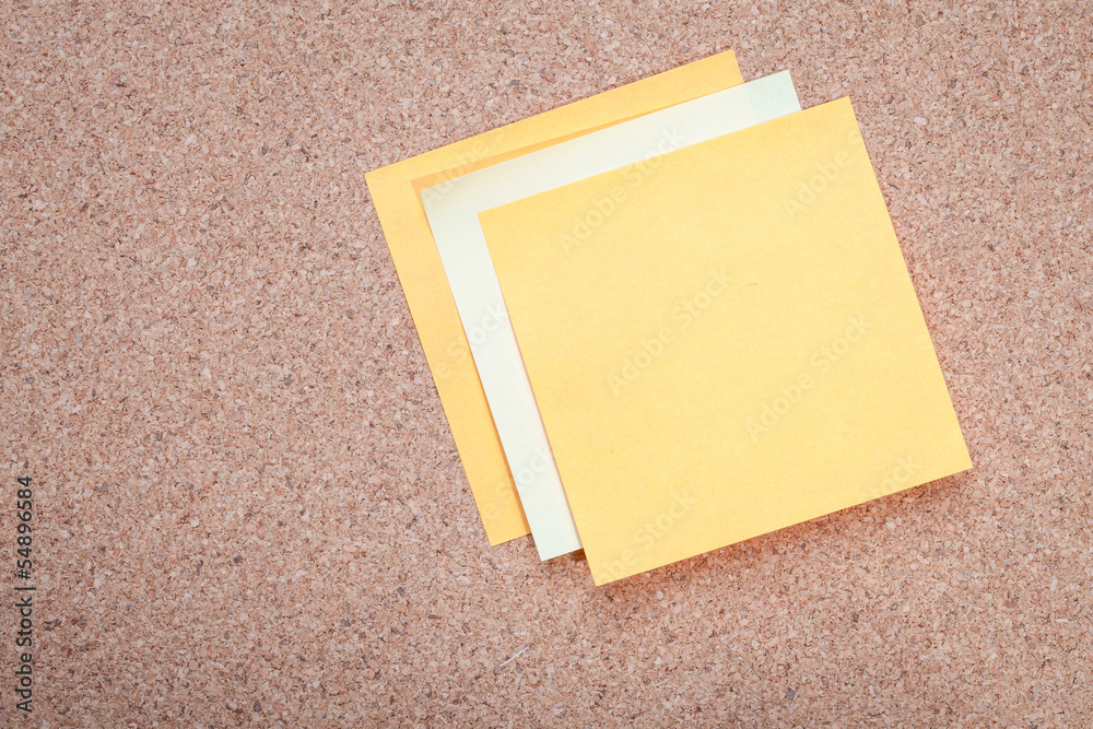 Sticky note on cork board Sticky note on cork board