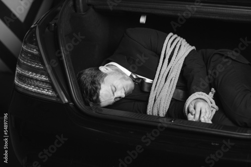 Kidnapped businessman. Black And White image of tied up young me