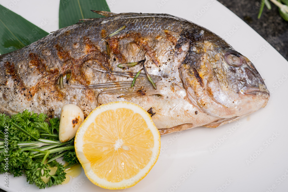 fresh fish cooked on the grill served on a platter fresh fish cooked on the grill served on a platter