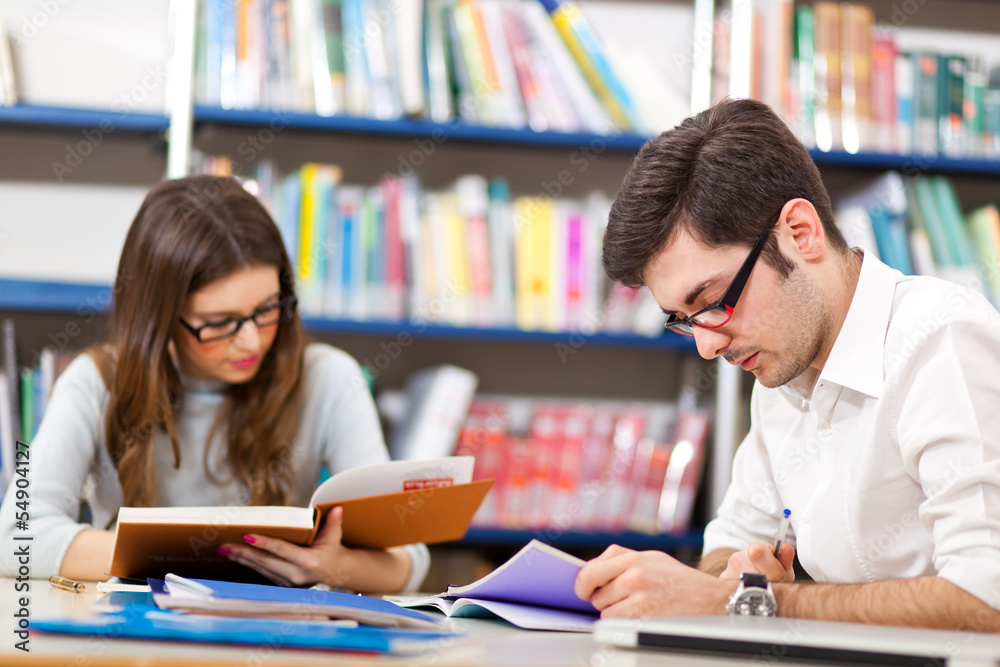 Students studying in a library Students studying in a library