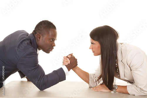 business man and woman arm wrestle serious