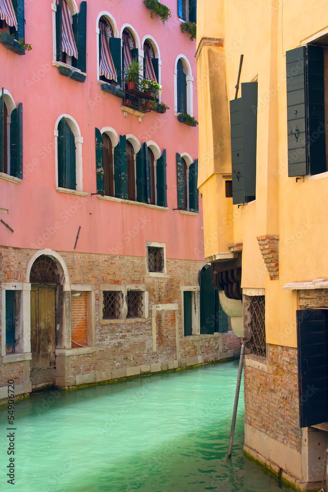 View of Canal in Venice with pink and yellow house