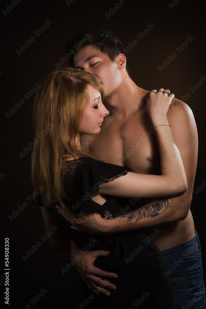 Beautiful young couple hugging and kissing Beautiful young couple hugging and kissing