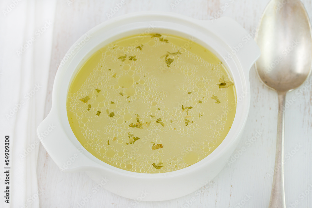 chicken broth in white bowl chicken broth in white bowl
