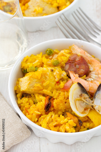 rice with seafood and meat in white dish