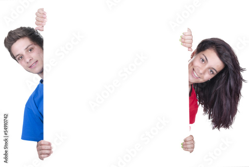 two teenagers holding at a blank board