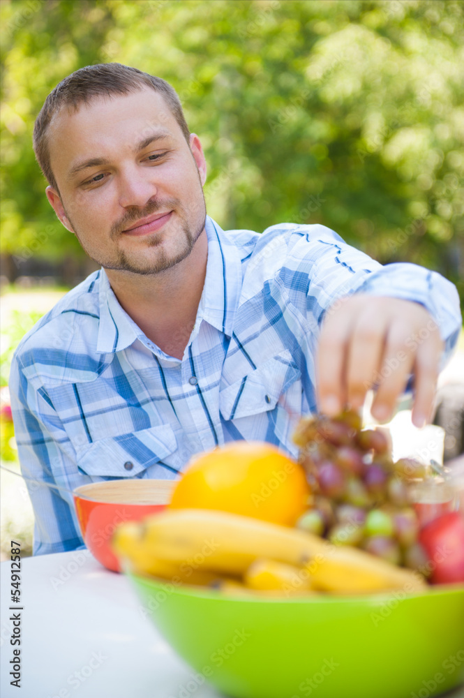 Fototapeta premium Man Enjoying Meal In Garden