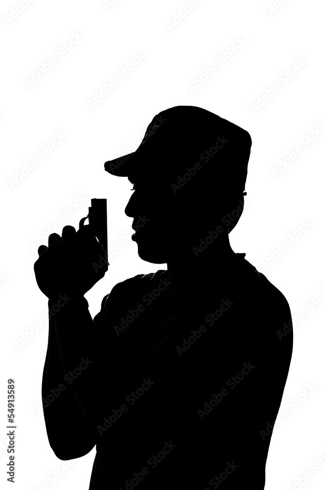 silhouette of a young male holding a gun.