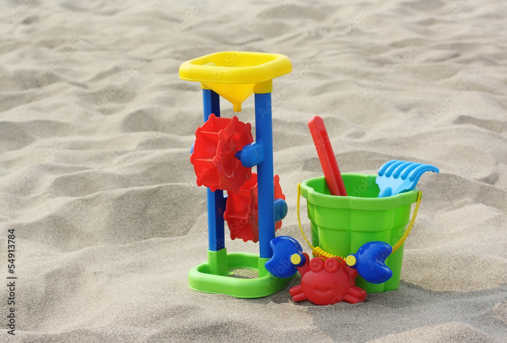 Children's toy: plastic bucket, mill, scoop, rake, form in the f Children's toy: plastic bucket, mill, scoop, rake, form in the f
