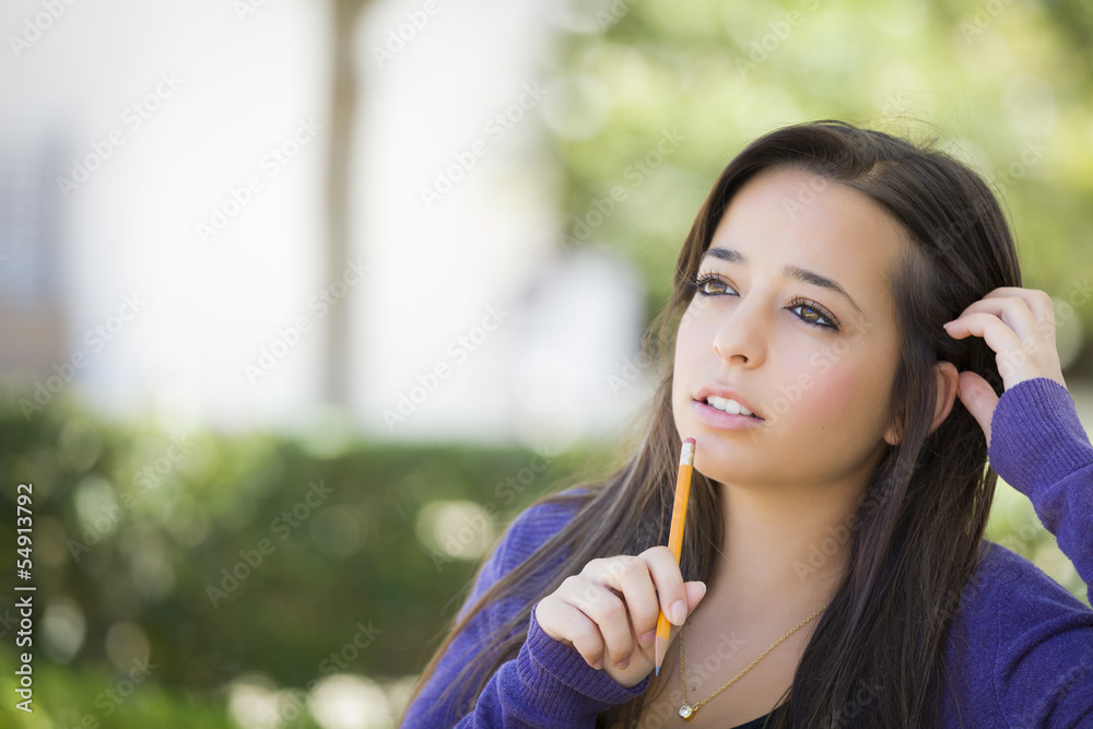 Pensive Mixed Race Female Student with Pencil on Campus Pensive Mixed Race Female Student with Pencil on Campus