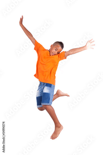 Portrait of a cute teenage black boy jumping over white backgrou