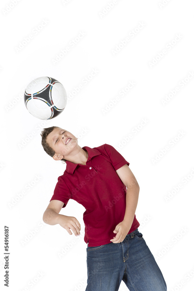 Boy kicking soccer ball with his head Boy kicking soccer ball with his head