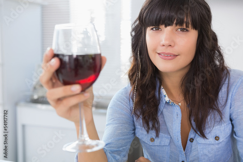 Pretty brunette having glass of red wine