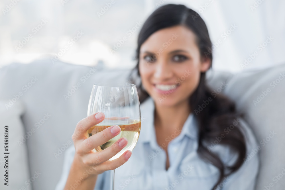 Seductive brunette offering white wine to camera Seductive brunette offering white wine to camera