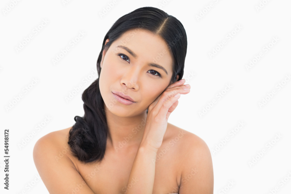 Sensual dark haired model touching her cheek Sensual dark haired model touching her cheek