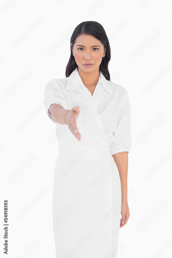 Elegant dark haired model with classy dress holding out her hand Elegant dark haired model with classy dress holding out her hand