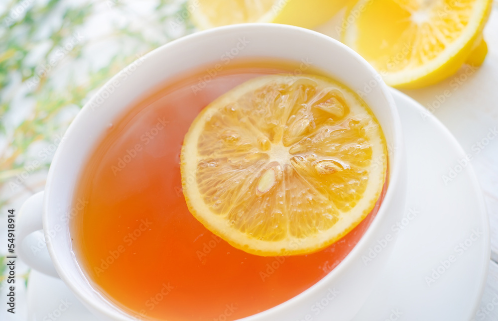 Fresh tea with lemon in the white cup Fresh tea with lemon in the white cup