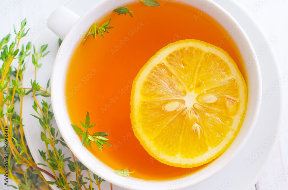 Fresh tea with lemon in the white cup Fresh tea with lemon in the white cup