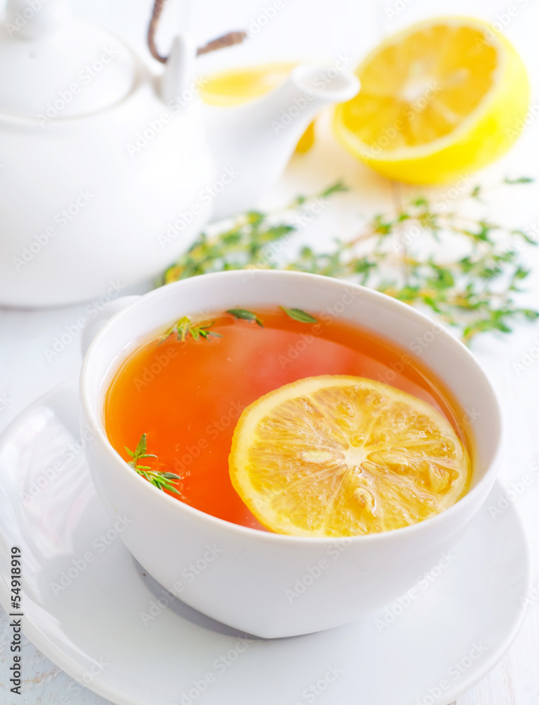 Fresh tea with lemon in the white cup Fresh tea with lemon in the white cup