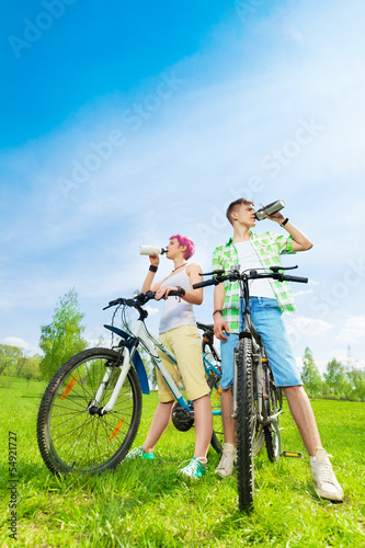 Young bikers with water bottles
