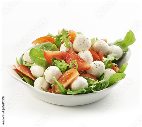 healthy fresh rucola salad with mozarella and tomato slices