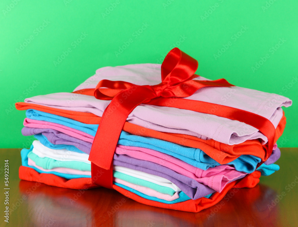Pile of clothing with red ribbon and bow Pile of clothing with red ribbon and bow
