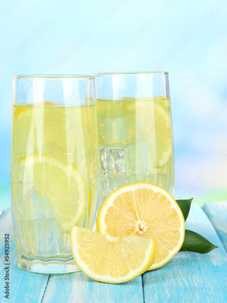 Delicious lemonade on table on blue background Delicious lemonade on table on blue background