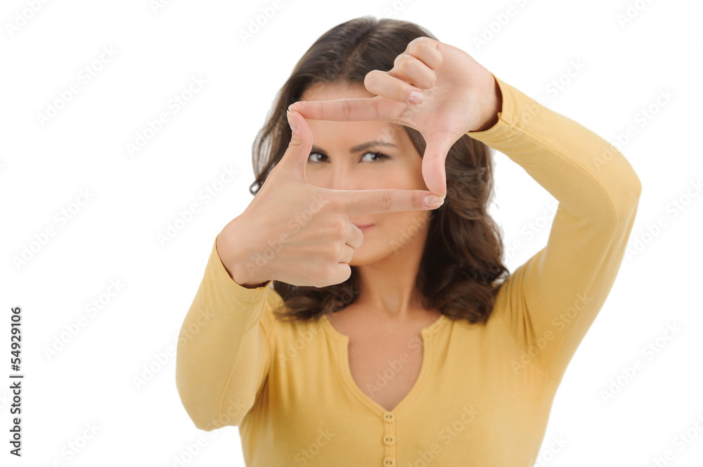 Finger frame. Beautiful young women looking through a finger fra Finger frame. Beautiful young women looking through a finger fra