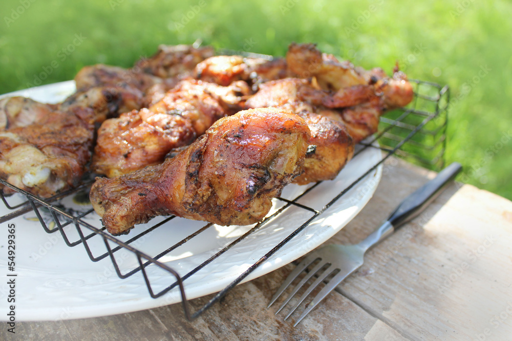 Chicken BBQ on a wooden table .