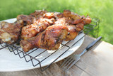 Chicken BBQ on a wooden table .