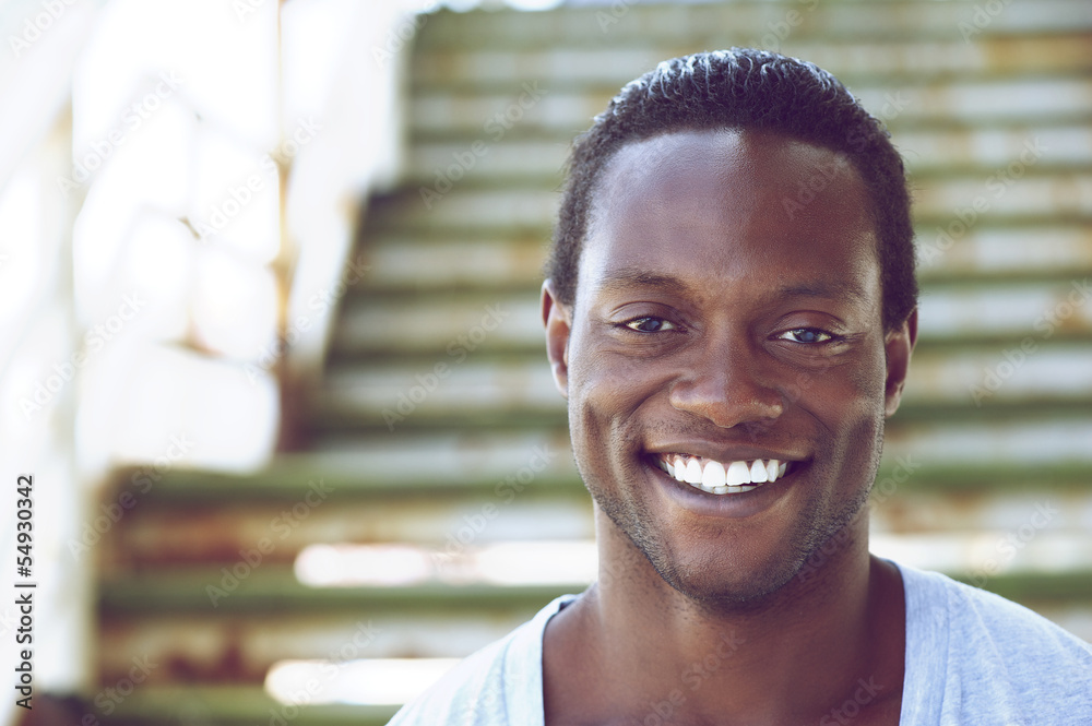 Fototapeta premium Portrait of an african american man smiling outdoors