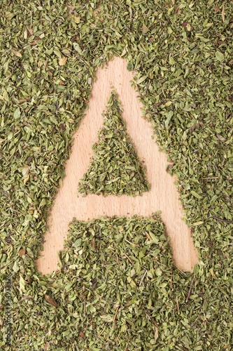 Letter A written with oregano