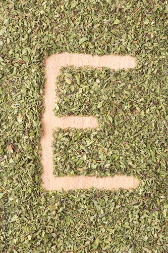 Letter E written with oregano